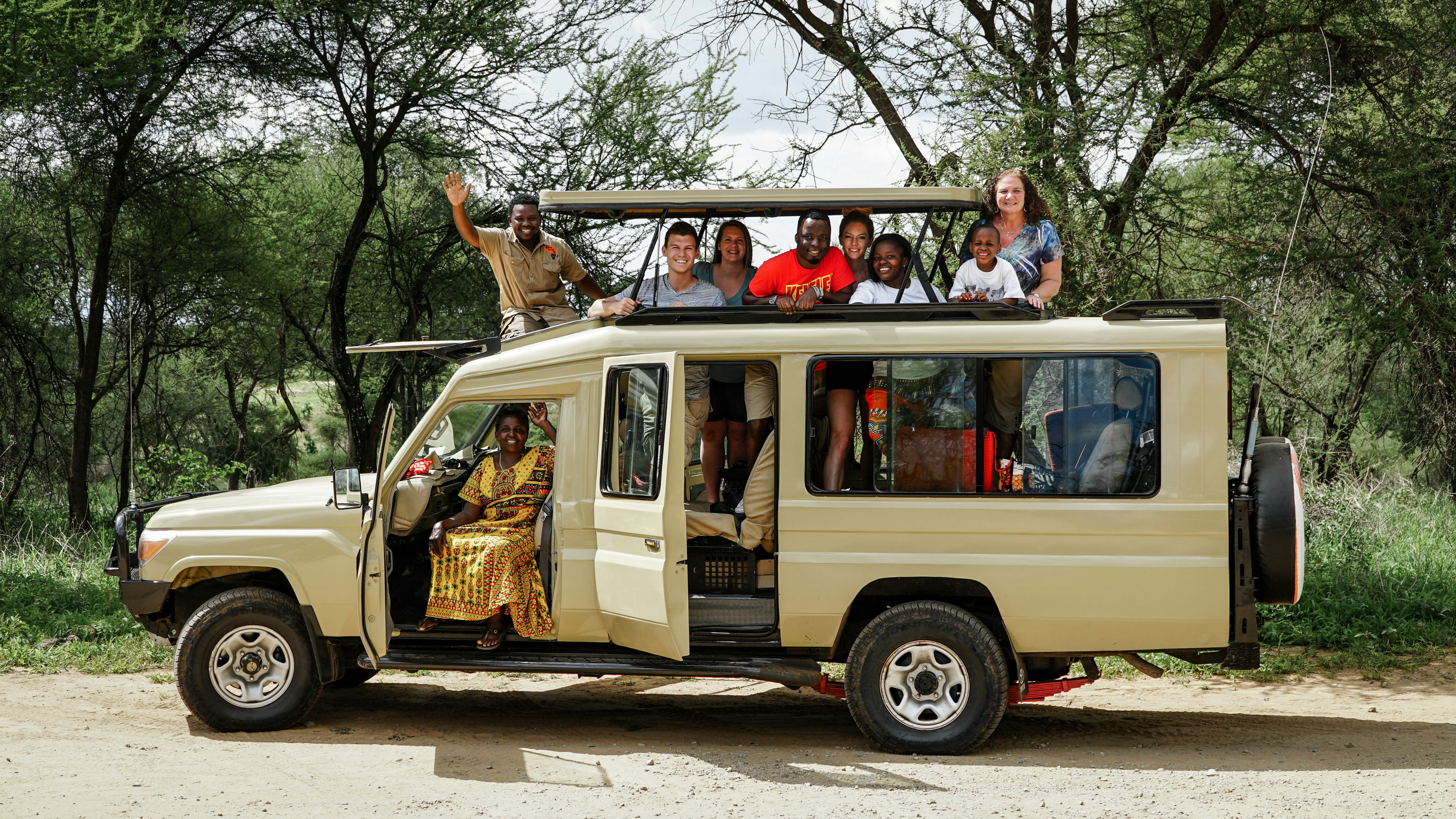 Open safari vehicle in golden light — safari with teenagers